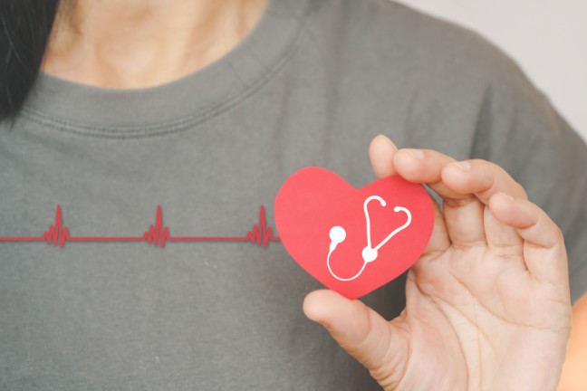 people holding red heart with white heartbeat icon, heart checking, annual health checking, world health day, health care, organ donation, insurance, world hypertension concept