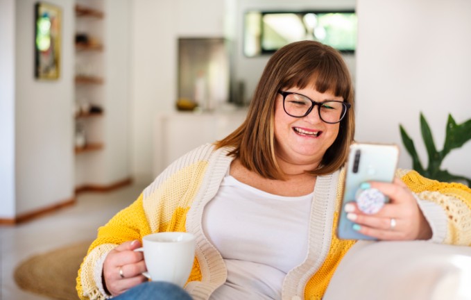 heavy set female on her phone watching bariatric educational videos
