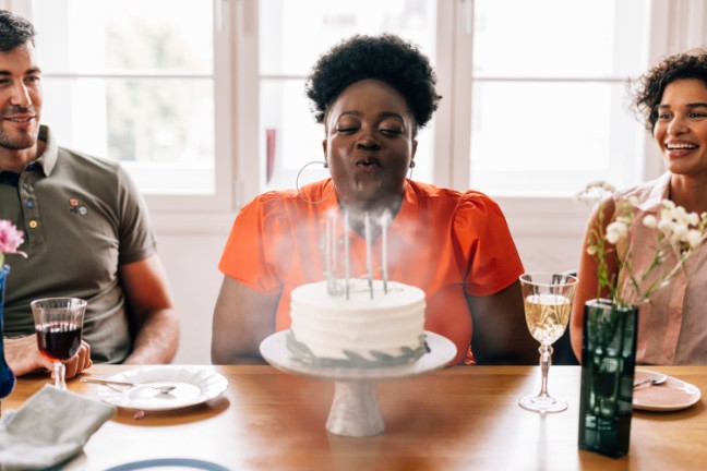 Woman with healthy lungs blowing out birthday candles