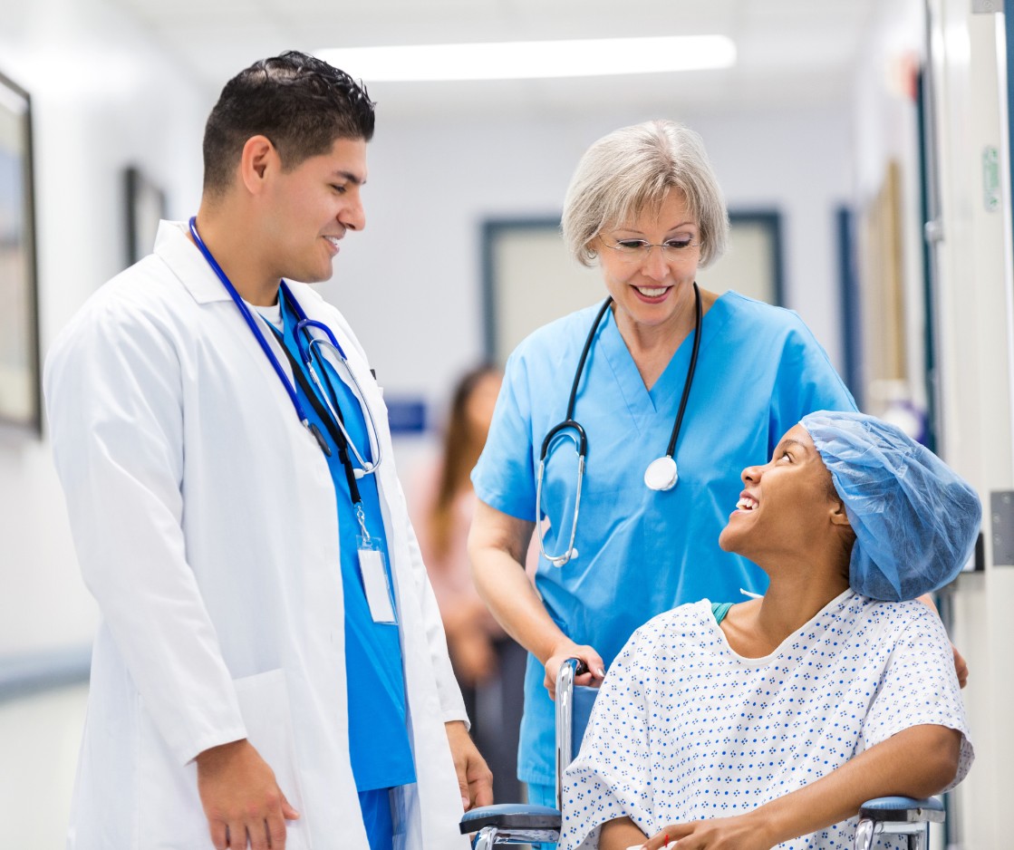 patient talking with doctor and nurse preparing for surgery