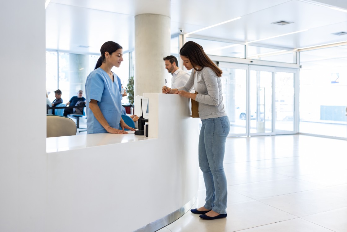 female visitor at hospital reception desk