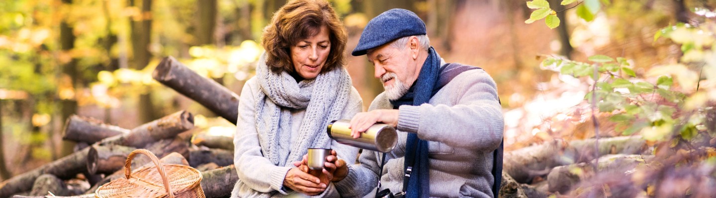 Seniors hiking and drinking coffee