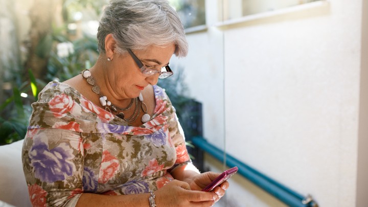 Woman researches insurance plans on her mobile device