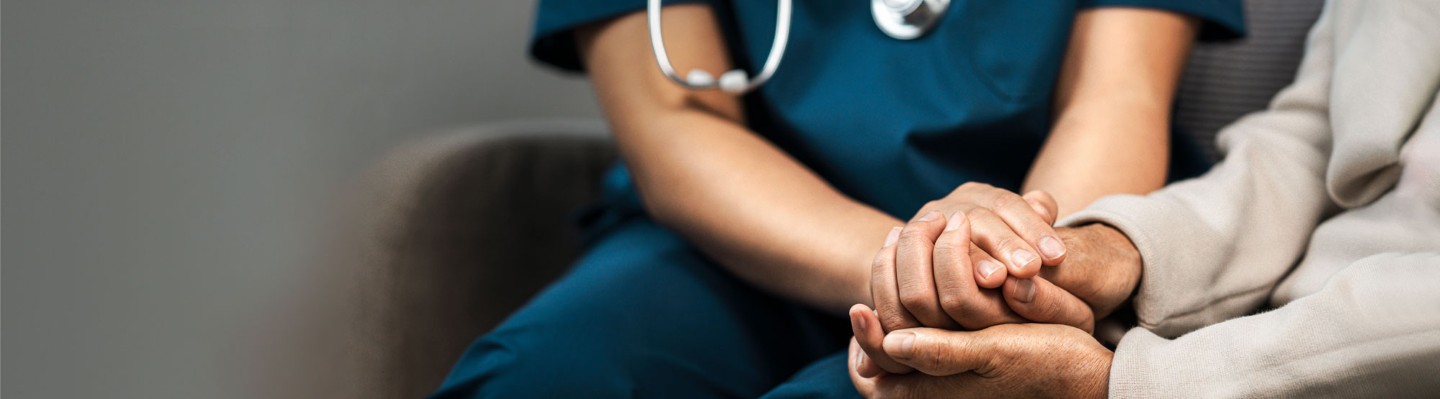 Medical provider holding hand of patient