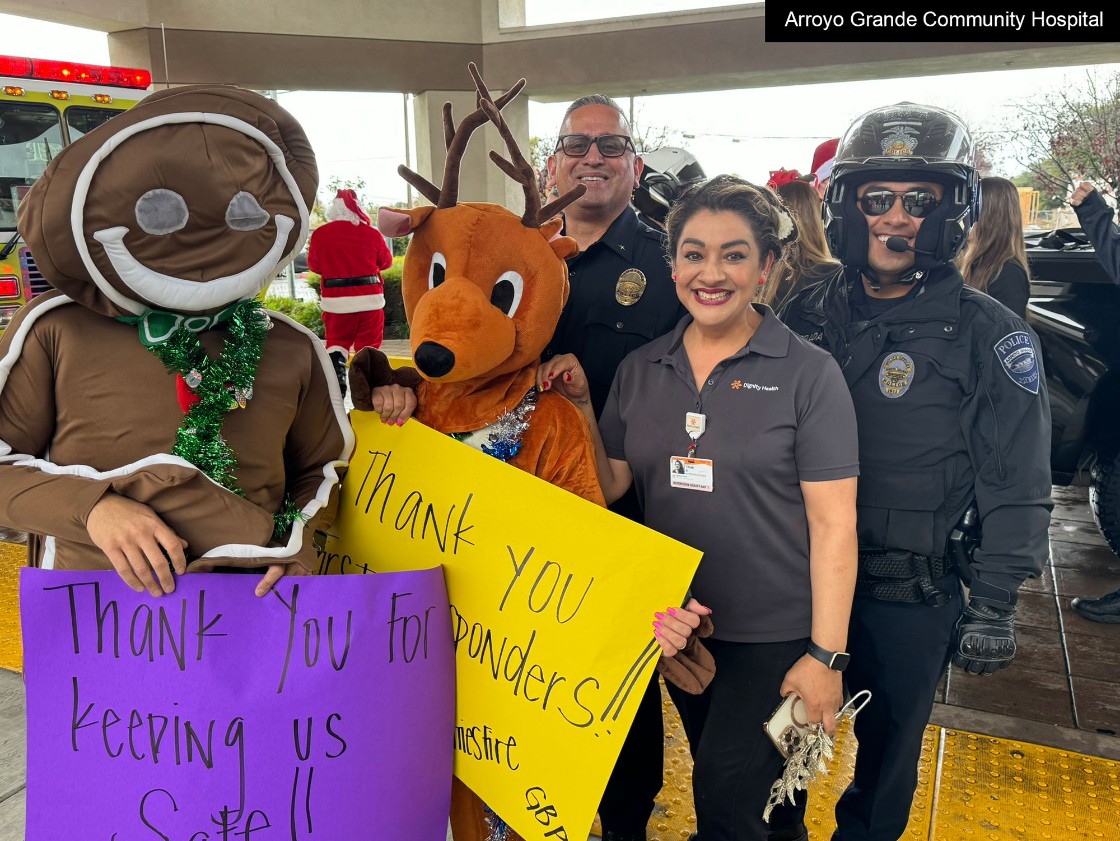 Arroyo Grande Community Hospital with law enforcement and hospital employee and a costumed gingerbread man and costumed reindeer