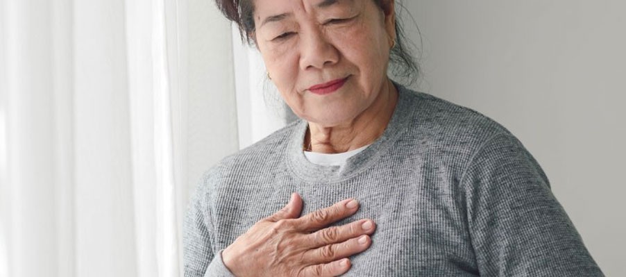 Senior woman holding hand over her heart