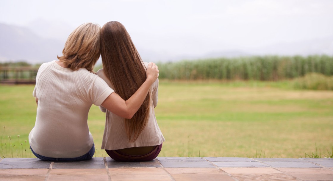 Mom and daughter sitting on porch