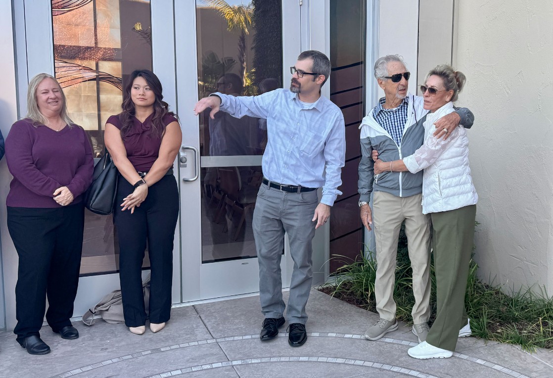 Bob Moloznik is hugged by his wife, Bobbie, during Friday's reunion with first responders and hospital personnel at French Hospital who worked to save his life after he went into cardiac arrest earlier this year. Also pictured are Deborah Moskowitz, left, and Jessica Kwong, second from left, Pismo Beach Police dispatchers, and Dr. William Mulkerin, center, the Medical Director for San Luis Obispo County Emergency Medical Services Agency. 