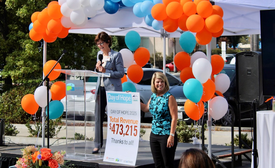 Sue Andersen, President & CEO of Marian Regional Medical Center and Arroyo Grande Community Hospital, unveils the record-breaking fundraising total from Day of Hope 2025, along with Denise Villarete, the Day of Hope ambassador for Santa Maria, during Thursday's celebration event. 