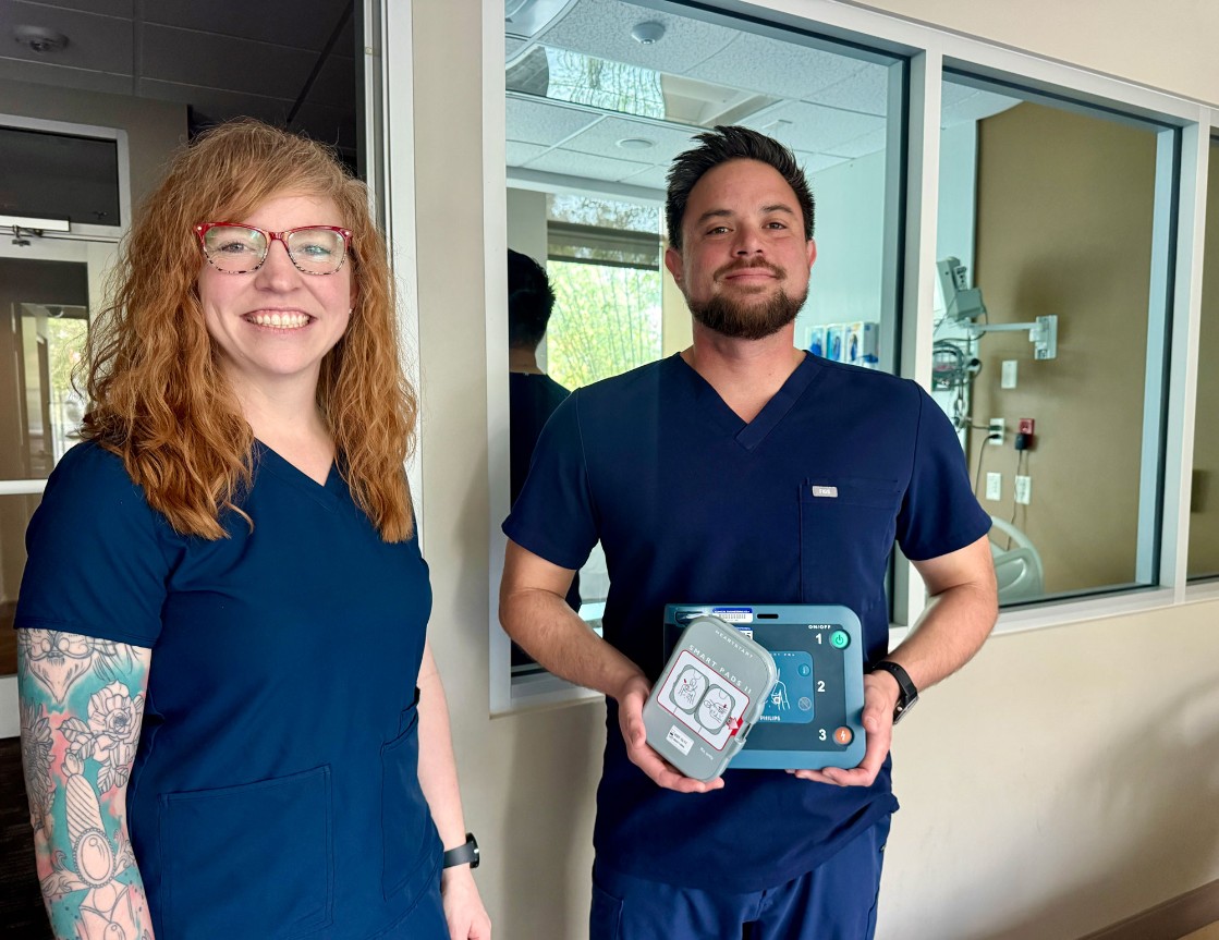 Jessica Bower, the Senior Director of Cardiovascular Services for Dignity Health Central Coast, and Greg Larsen, AED Program Coordinator at French Hospital, pose with an AED unit. French Hospital has received a grant that will help distribute 20 AEDs throughout the City of San Luis Obispo. 