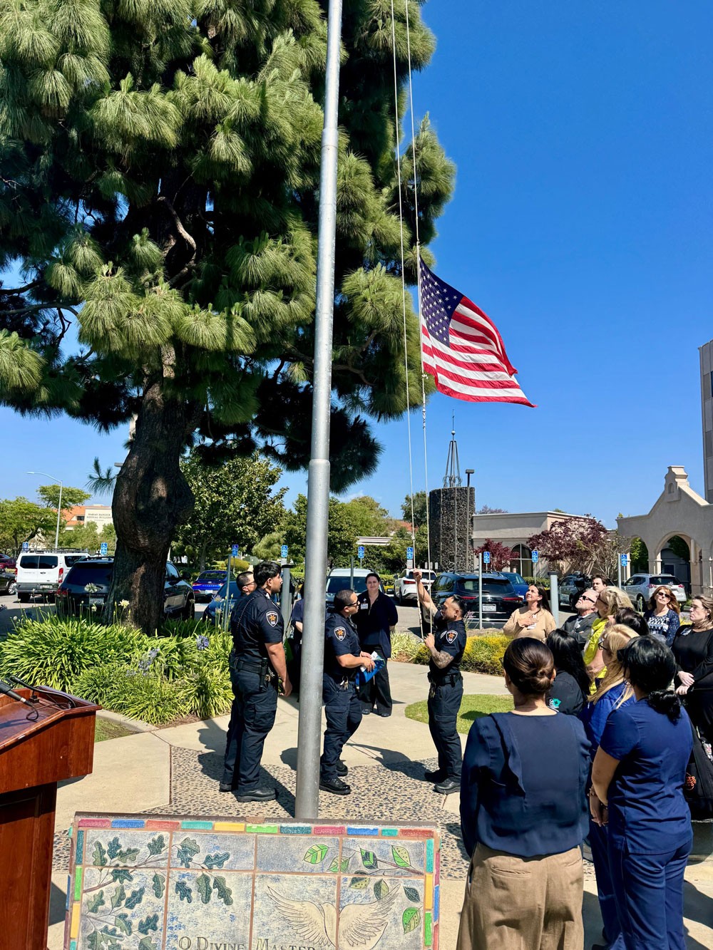 Members of the security team at Marian Regional Medical Center raise the Donate Life flag during a ceremony on Thursday, April 30, to mark Donate Life Month. Marian, in partnership with OneLegacy, hosted the flag-raising ceremony to highlight the critical need for organ, eye and tissue donations.