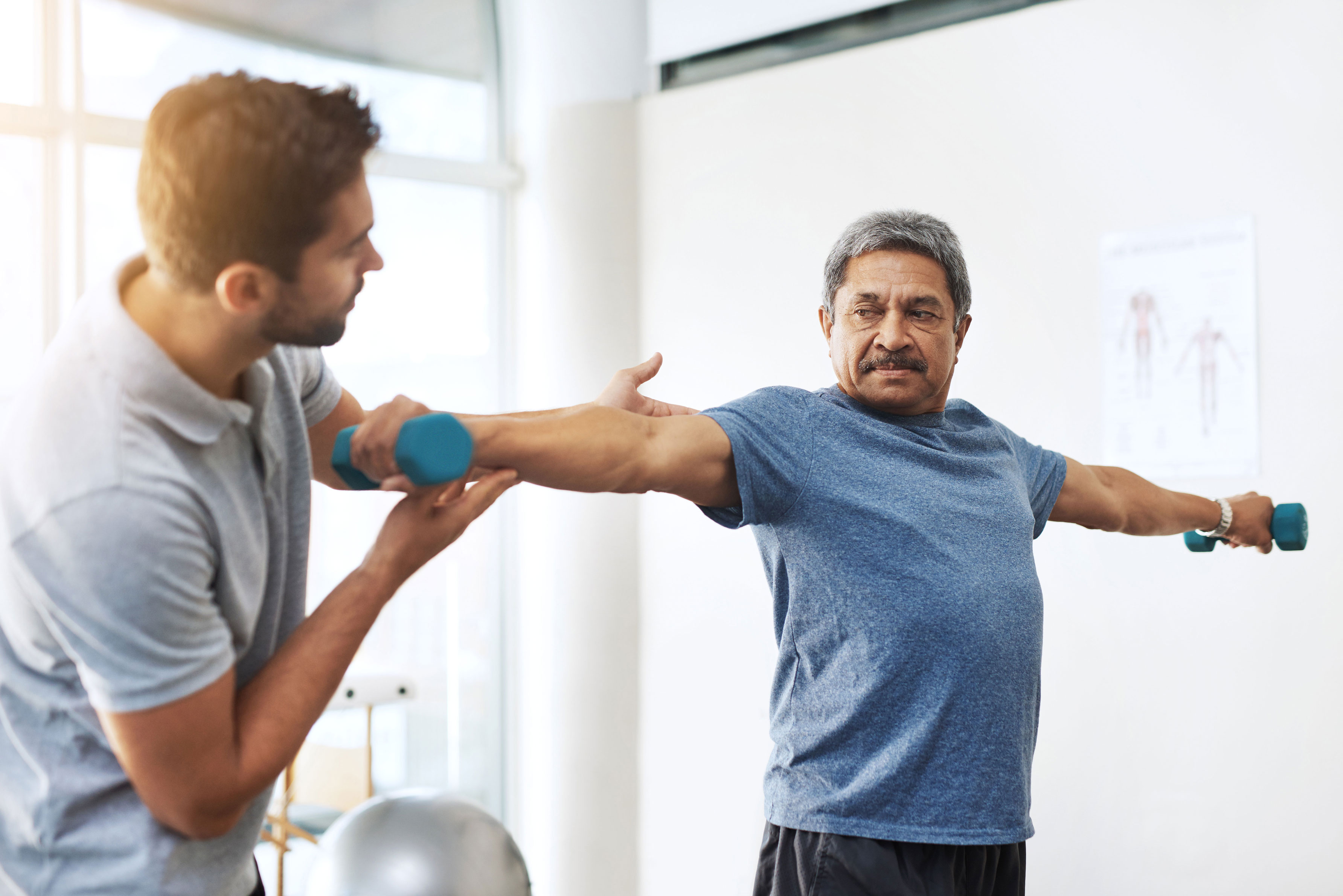 Image of physical therapist helping patient with strength training