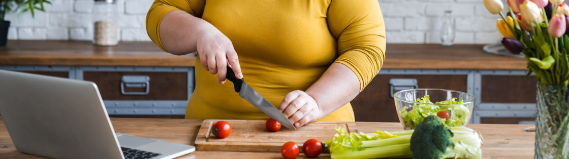 Woman cutting tomatoes on a cutting board
