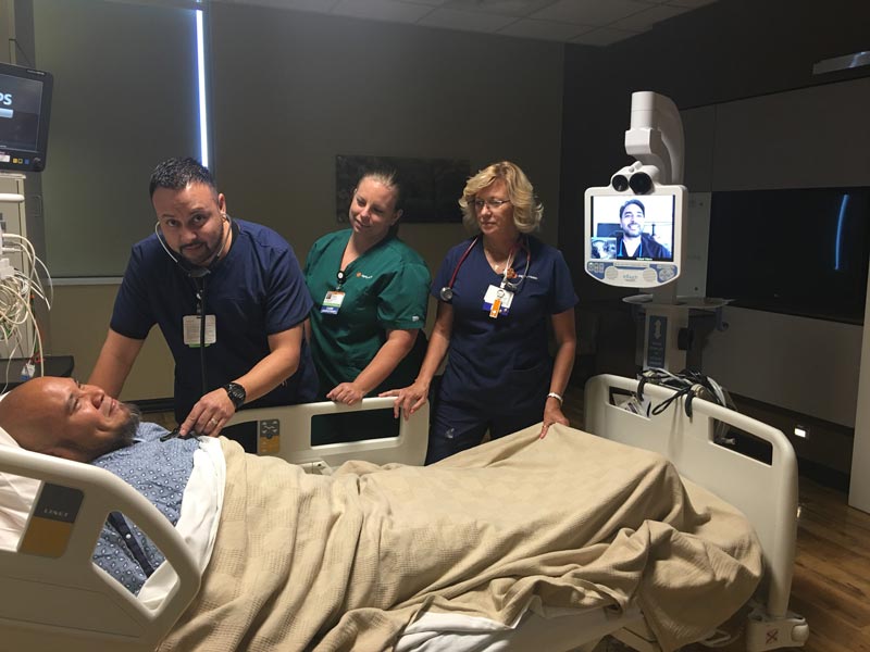 A medical team employs a telemedicine robot in an ICU