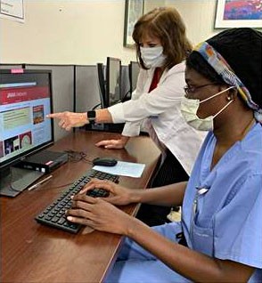 One doctor showing another a computer program.