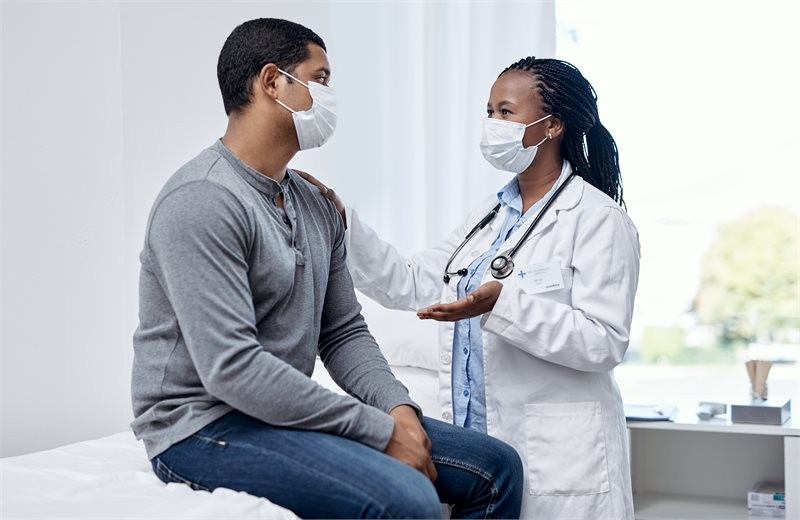 A man speaks with a female doctor