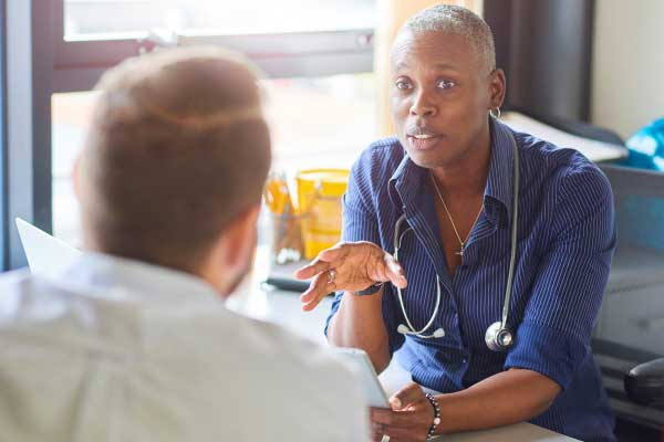 A physician speaks to a patient