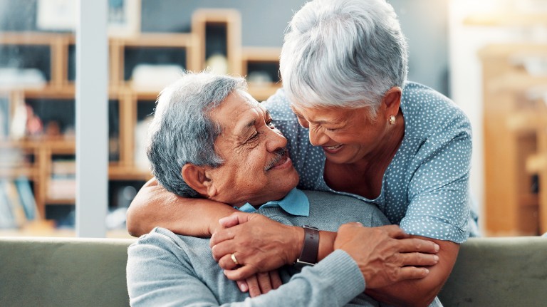 elderly couple embracing in hug