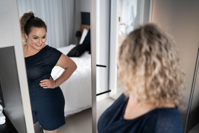 Dignity Health Bariatric and weight loss patient looking in the mirror 