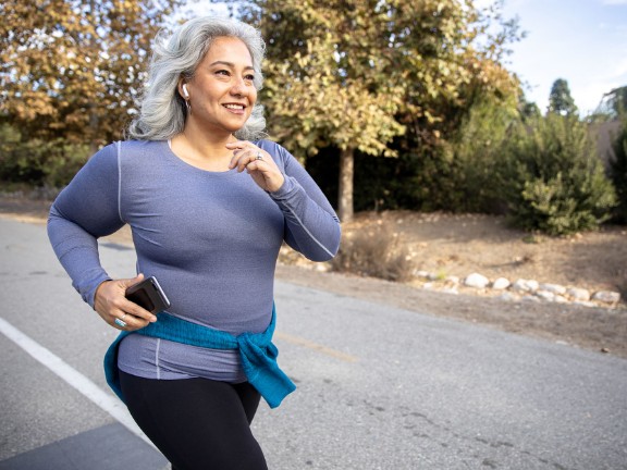 older woman running on road