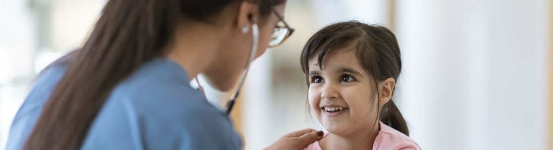 Doctor checking pediatric patients heartbeat with stethescope