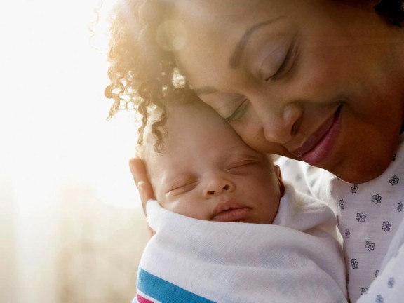 Mom and infant smiling